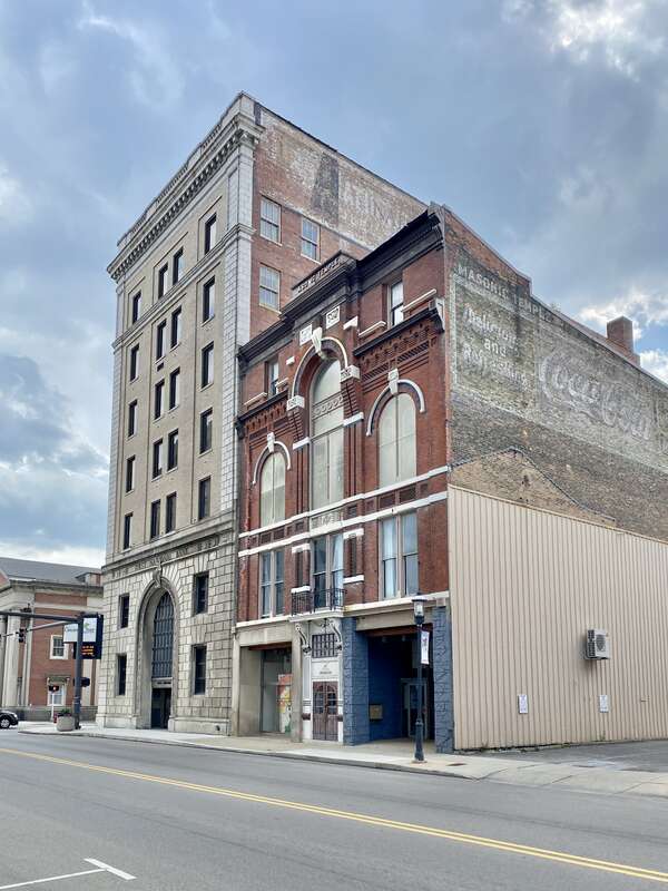 Built in 1883, this Romanesque Revival and Italianate-style building was constructed to serve as a Masonic Temple.  The building features a red brick exterior with roman arched window bays on the third floor, one-over-one double-hung windows, a