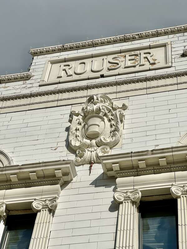 Built in 1855 and renovated to its present First Renaissance Revival-style appearance around the turn of the 20th Century when it was home to the drug store of Christian Rouser, this building is clad in painted brick with a green marble and white