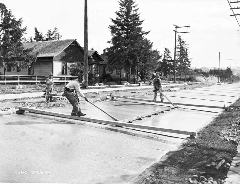 Workers paving 10th Ave. N. (now Roosevelt Way NE) near 61st St., Seattle, Washington, U.S., 1921.