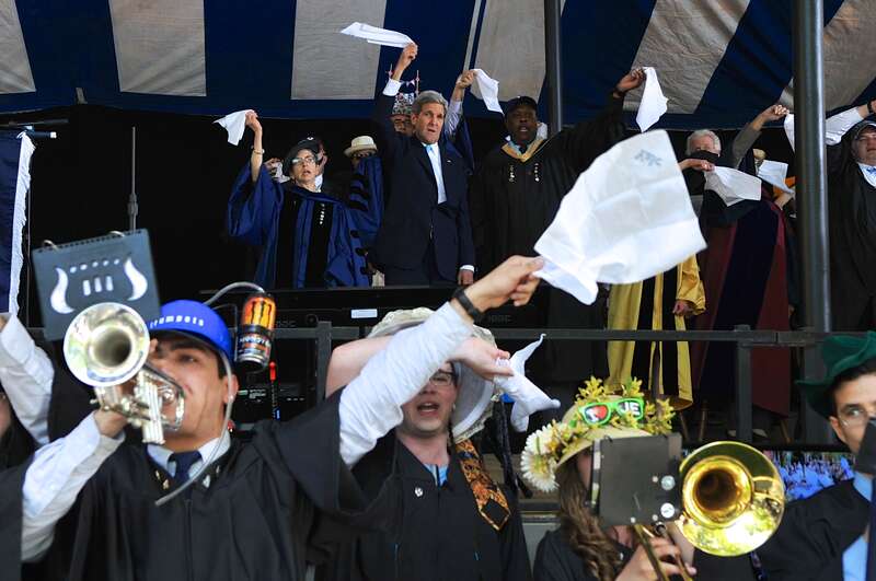 U.S. Secretary of State John Kerry waves a white handkerchief as the Class of 1966 member joins in a Yale University tradition after he addressed Class Day ceremonies in New Haven, Connecticut, on May 18, 2014. [State Department photo/ Public Domain]