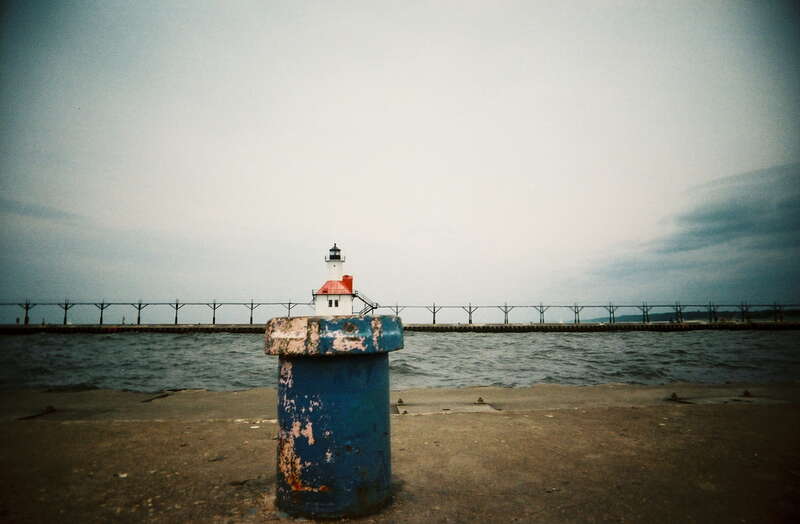 A boring lighthouse, bad lighting, and the family already walking ahead and tired of waiting for me... time to fall back to the old perspective trick... St. Joseph Pier in Michigan with the Vivitar Ultra Wide &amp;amp; Slim. (Explore)
