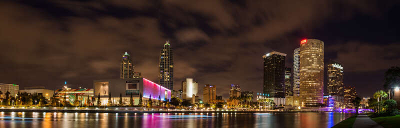Long exposure multile image composite panoramic of the city of Tampa Florida at night as seen from across the Hillsbourough River on the grounds of thr UT campus.