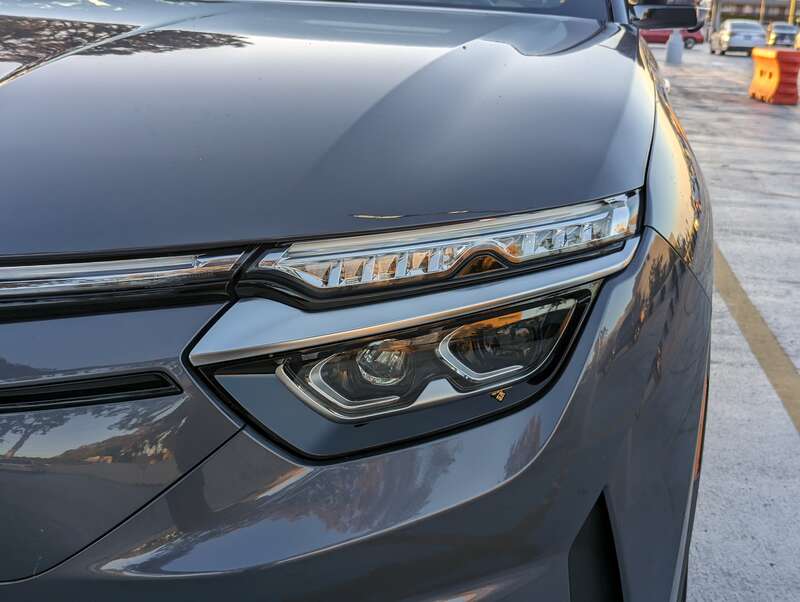The VF8 is a battery-electric SUV made by Vinfast. This example is gray and was parked at Hillsdale Shopping Center in San Mateo, California.