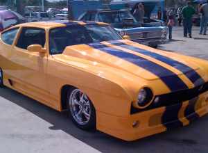 1974 AMC Matador custom 401 CID V8 coupe finished in yellow with purple stripes, right side view