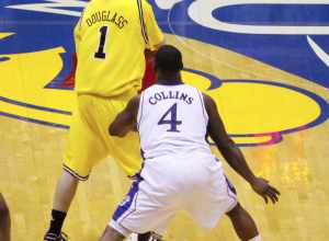 Stu Douglass of the 2009–10 Michigan Wolverines men's basketball team guarded by Sherron Collins