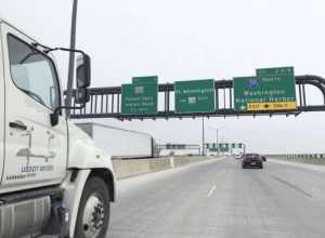 Signs for Exit 2 (Interstate 295 North, Washington, National Harbor) and Exit 3 (Maryland State Route 210, Forest Heights, Indian Head) on the Woodrow Wilson Bridge (northbound Interstate 95 and the eastbound outer loop of the Capital Beltway