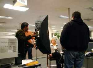 Times photographer Nader Khouri adjusts a lamp and photographer Mark DuFrene stands in the background as producer Karim Amir watches Political Editor Lisa Vorderbrueggen.