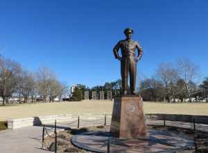 Dwight D. Eisenhower statue in "Champion of Peace" circle, with memorial pylons in background.