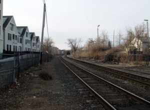 Fitchburg Line corridor, looking west from Park Street in Somerville. Somerville station, closed in 1938, was located on the north side of the tracks at the right side of the photo.