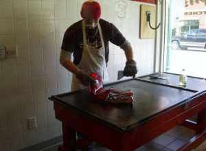 Man making red hot candy drops at Schimpff's Confectionary.