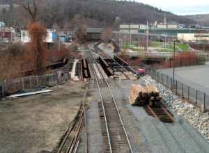 One of several railroad bridges over the Nashua River in Fitchburg, this one with an unusual arrangement - a switch to a former siding located on the bridge itself. Track work for the extension to Wachusett was under way on the right bays of the