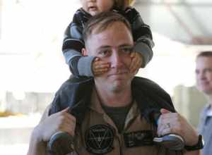 U.S. Marine Corps Capt. William R. Houck with Marine Aerial Refueler Transport Squadron (VMGR) 352, Marine Aircraft Group (MAG) 11, 3rd Marine Aircraft Wing (MAW), holds his son on his shoulders on Marine Corps Air Station Miramar, Calif., Jan. 15,