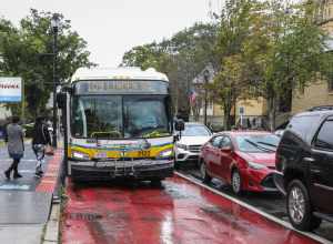 An MBTA route 109 bus on Broadway in Everett in September 2021. At left is a portable structure to test level boarding.