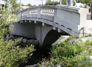 Historic Moores Creek Bridge located in Fort Pierce, Florida.   The bridge was built in 1925 by the Luten Bridge Company and is listed as a registered historic site.  The bridge is locally known as Tickle Tummy Hill due to its high arch compared to