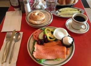 Nova lox, toasted sesame seed bagel, cream cheese, and optional toppings, before being assembled into a sandwich. This is the "lox platter for one" at The Bagel restaurant in Skokie, Illinois, United States.