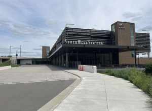 SouthWest Station in June 2024. Underneath the parking structure on the right are the platforms for the Green Line. On the left are areas for buses and an indoor bus waiting area.
